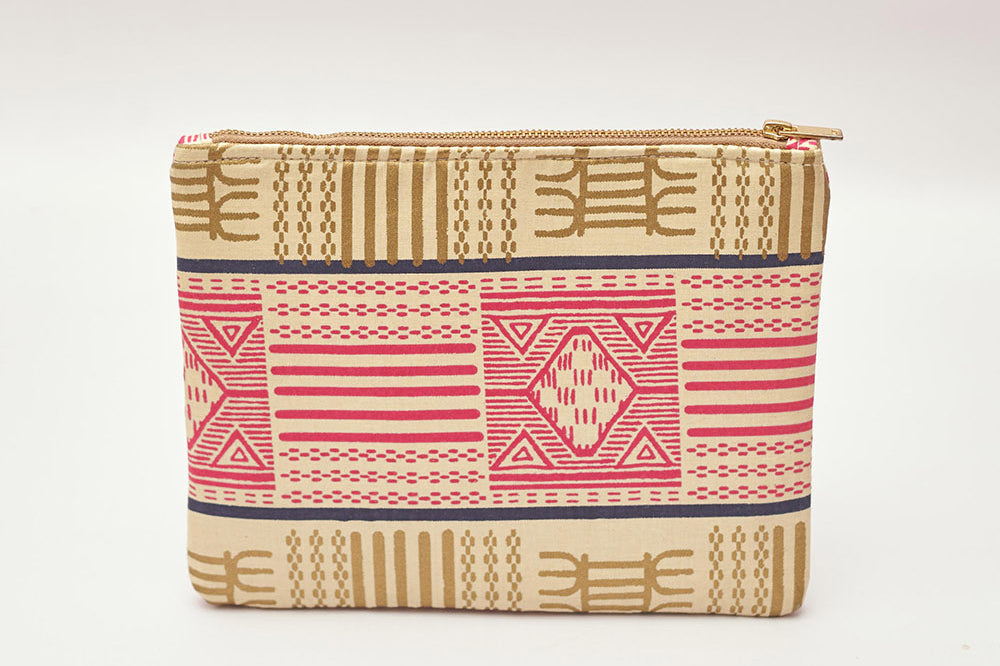 Tan and pink hand-dyed Kente print Zipper Clutch by GEOMETRIC.