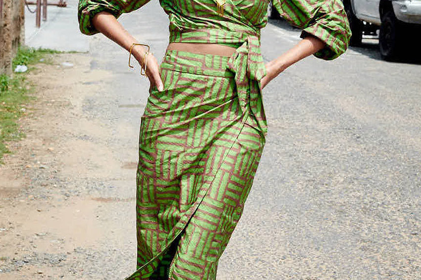 Woman wearing matching green hand-dyed batik Garden Party print long sleeve wrap top and wrap skirt by GEOMETRIC.