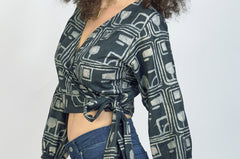 Woman wearing charcoal hand-dyed batik Coco print long sleeve wrap top by GEOMETRIC.