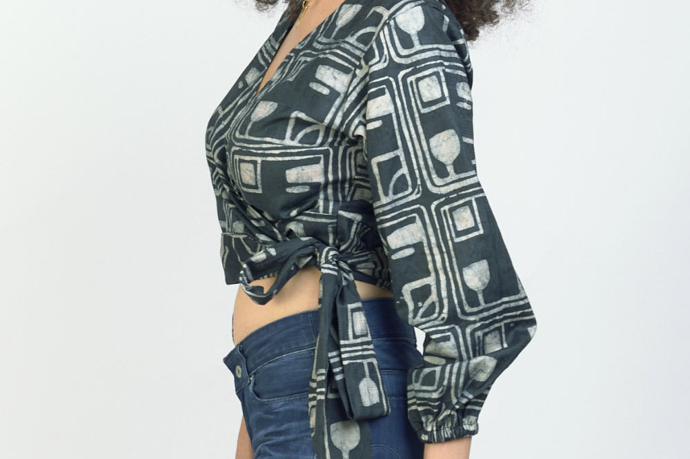 Woman wearing charcoal hand-dyed batik Coco print long sleeve wrap top by GEOMETRIC.