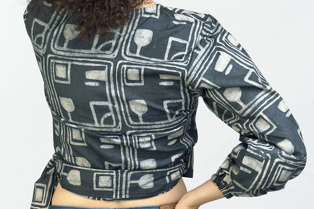 Woman wearing charcoal hand-dyed batik Coco print long sleeve wrap top by GEOMETRIC.