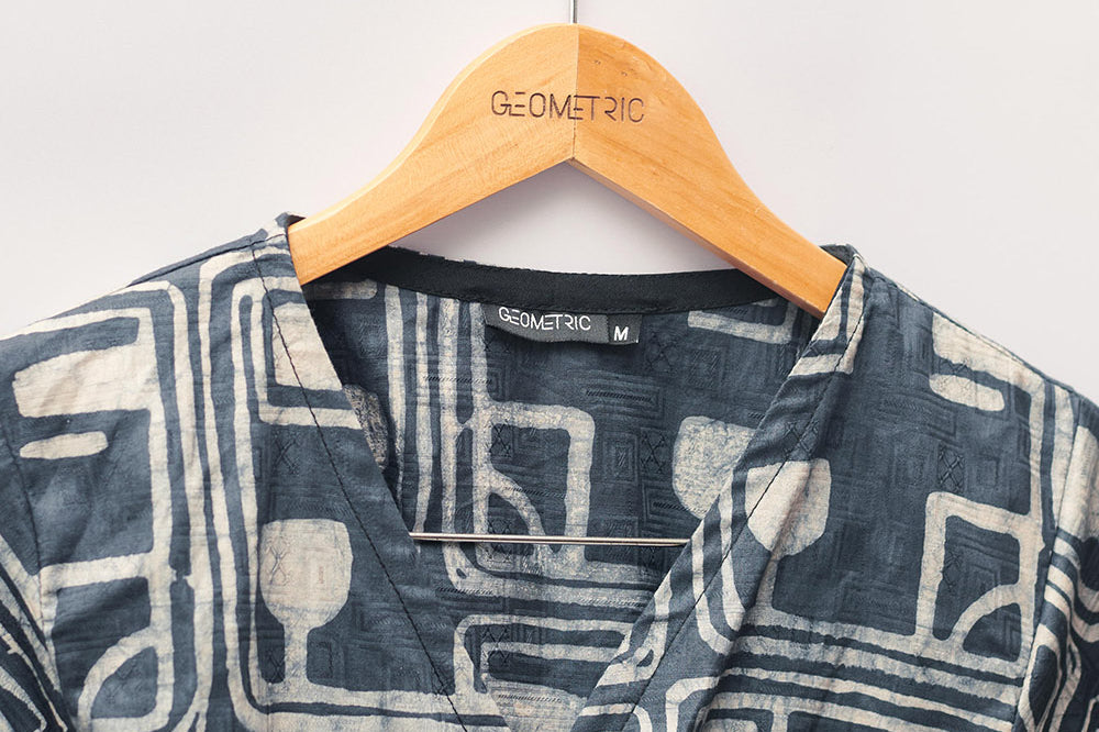 Close-up of charcoal hand-dyed batik Coco print long sleeve wrap top by GEOMETRIC.