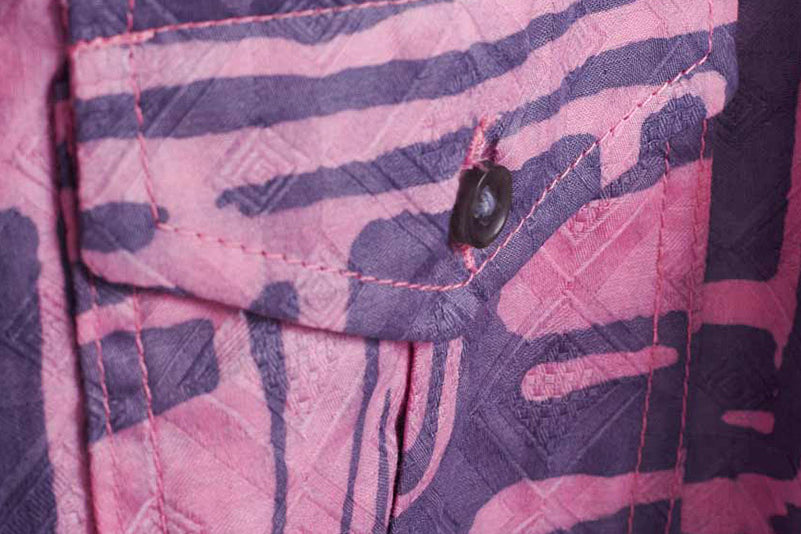 Close-up of hand-dyed blue Coco batik print short sleeve button up shirt by GEOMETRIC.
