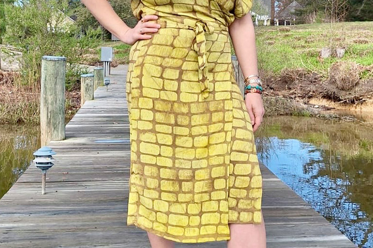 Woman wearing hand-dyed yellow techno wrap dress by GEOMETRIC.