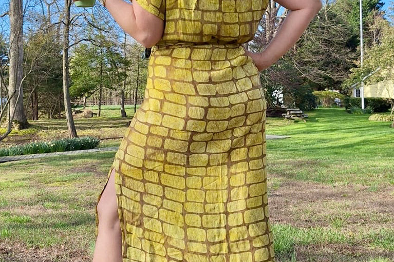 Back view of woman wearing hand-dyed yellow techno wrap dress by GEOMETRIC.