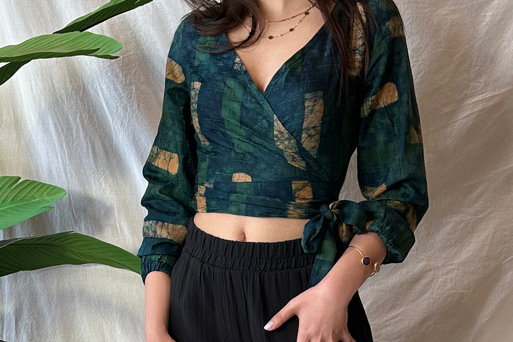 Woman wearing navy hand-dyed batik Brush Strokes print long sleeve wrap top by GEOMETRIC.