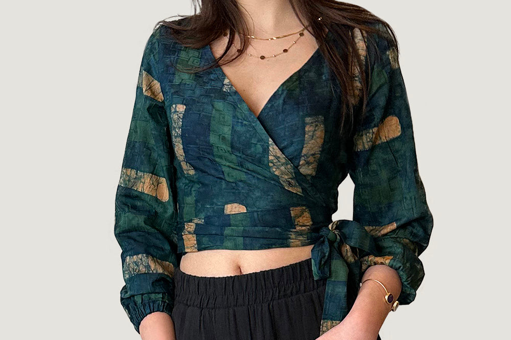 Woman wearing navy hand-dyed batik Brush Strokes print long sleeve wrap top by GEOMETRIC.