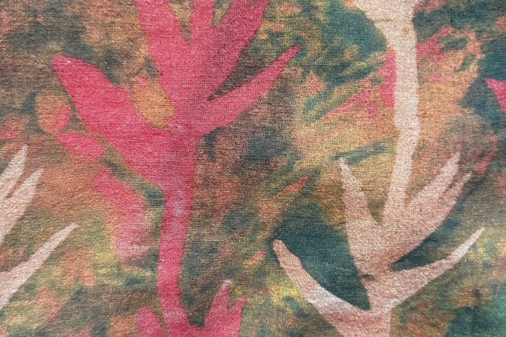 Close-up of hand-dyed fall colour Paradise batik print Short Sleeve Wrap Top by GEOMETRIC. 