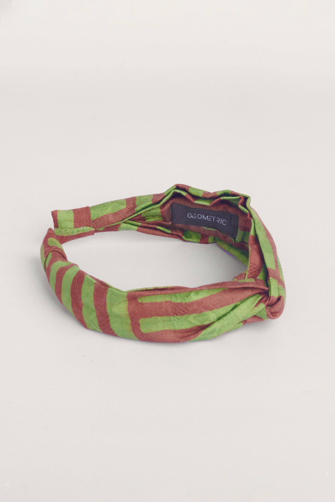 Green and brown hand-dyed batik Garden Party print headband by GEOMETRIC. 