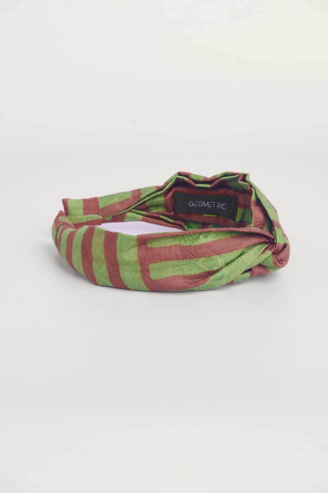 Green and brown hand-dyed batik Garden Party print headband by GEOMETRIC. 