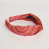 Red hand-dyed batik Shea Shell print headband by GEOMETRIC. 
