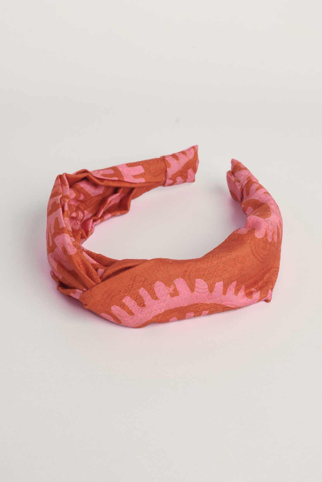 Red hand-dyed batik Shea Shell print headband by GEOMETRIC. 