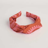 Red hand-dyed batik Shea Shell print headband by GEOMETRIC. 