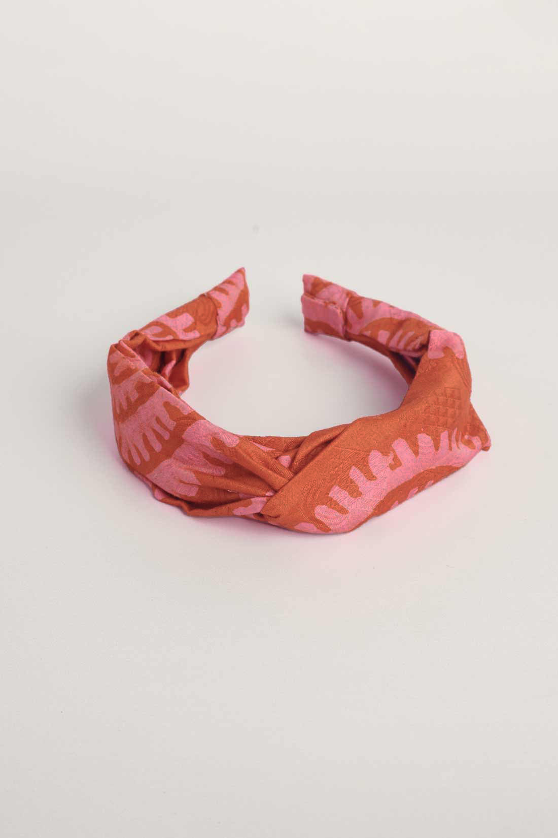 Red hand-dyed batik Shea Shell print headband by GEOMETRIC. 
