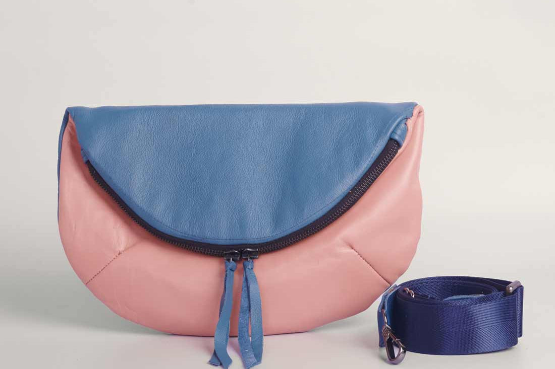 Stone blue and pick leather Crescent cross-body bag by GEOMETRIC. 