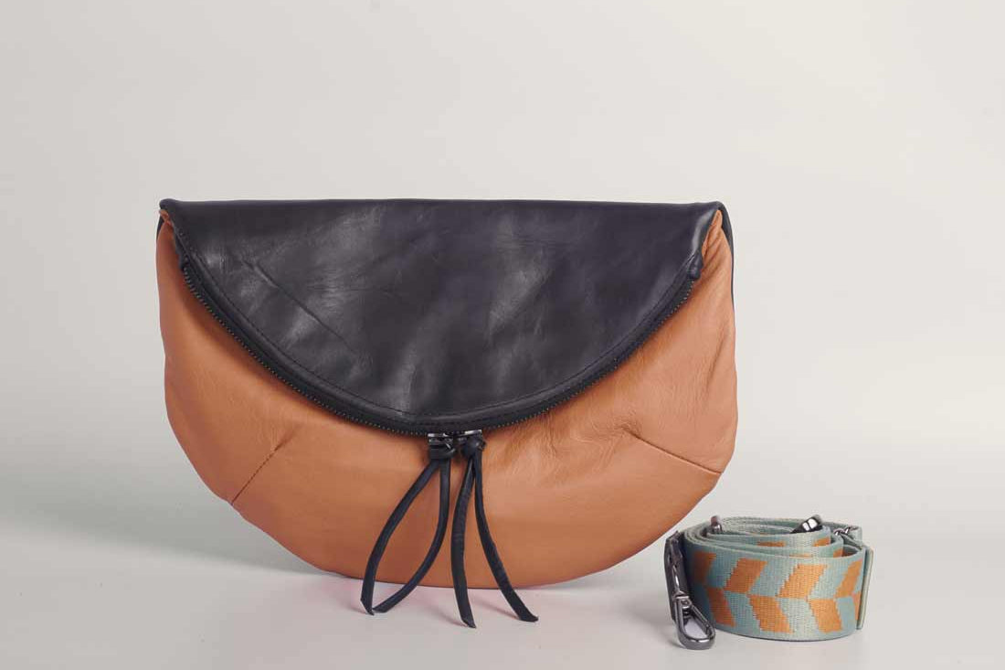Dusty orange and black leather Crescent cross-body bag by GEOMETRIC. 