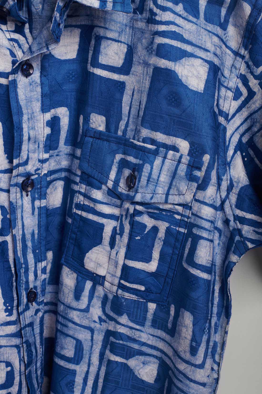 Hand-dyed blue Coco batik print short sleeve button up shirt by GEOMETRIC. 