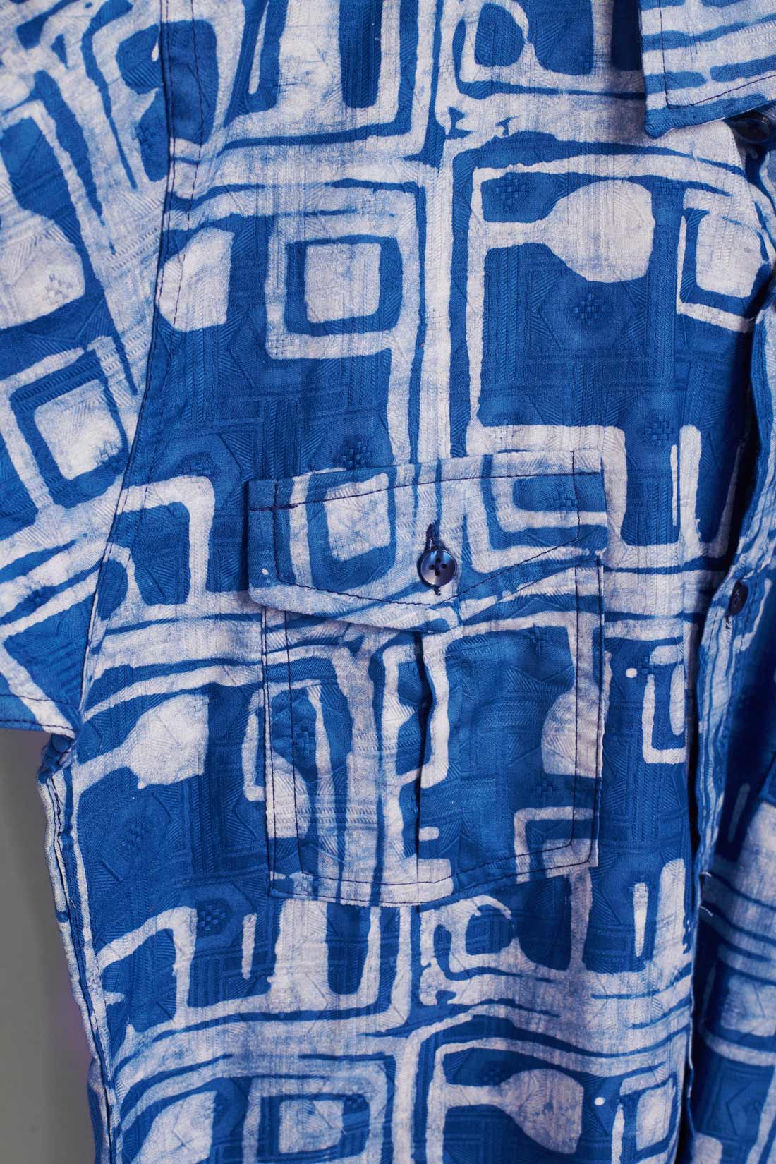 Hand-dyed blue Coco batik print short sleeve button up shirt by GEOMETRIC. 