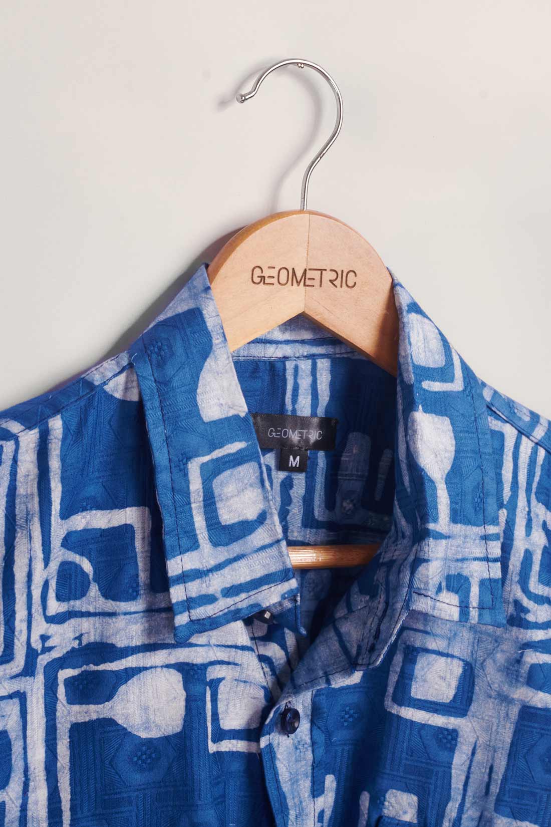 Hand-dyed blue Coco batik print short sleeve button up shirt by GEOMETRIC. 