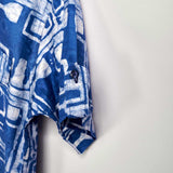 Close-up hand-dyed blue Coco batik print short sleeve button up shirt by GEOMETRIC. 