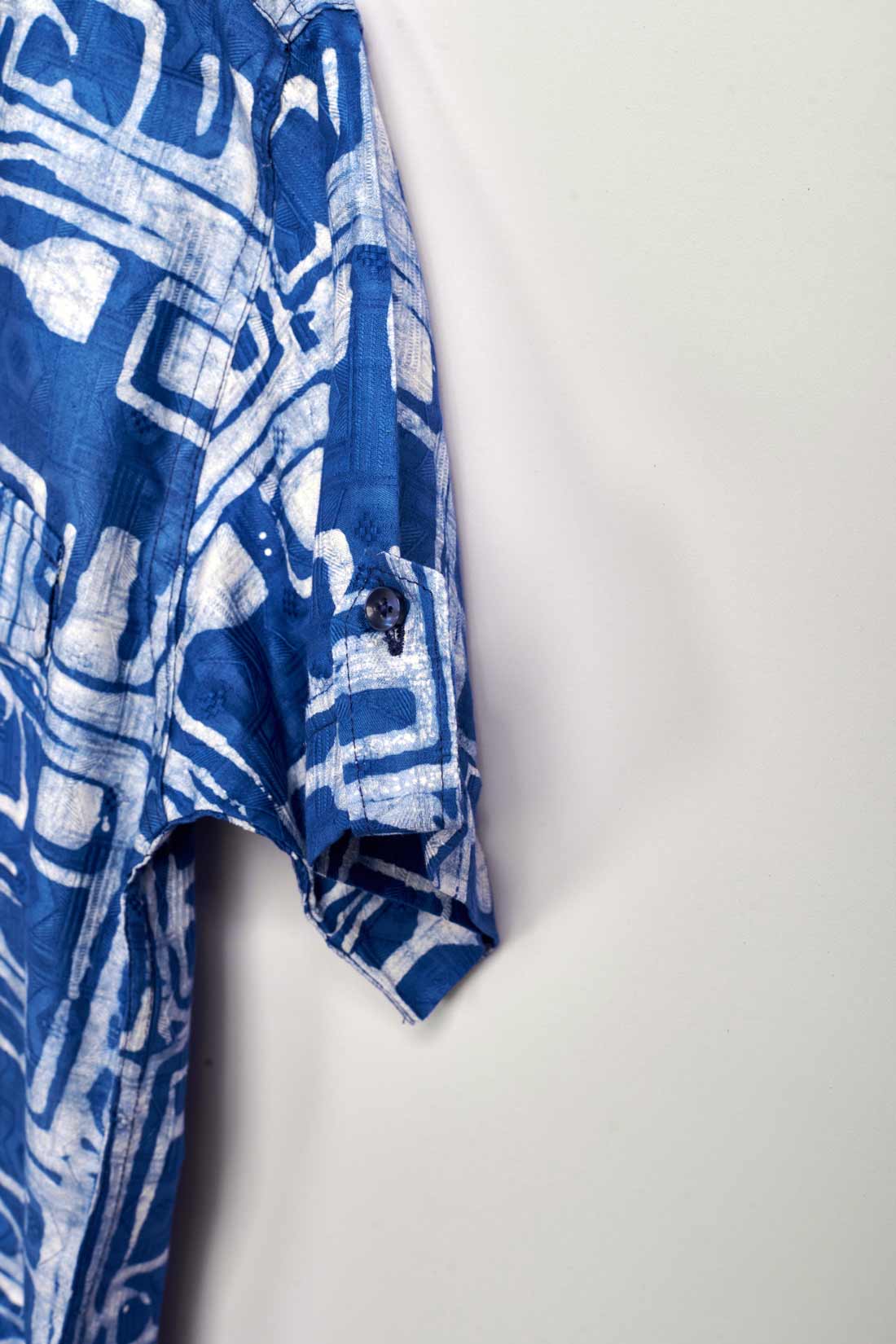 Close-up hand-dyed blue Coco batik print short sleeve button up shirt by GEOMETRIC. 