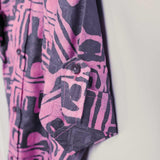 Close-up of hand-dyed blue Coco batik print short sleeve button up shirt by GEOMETRIC. 