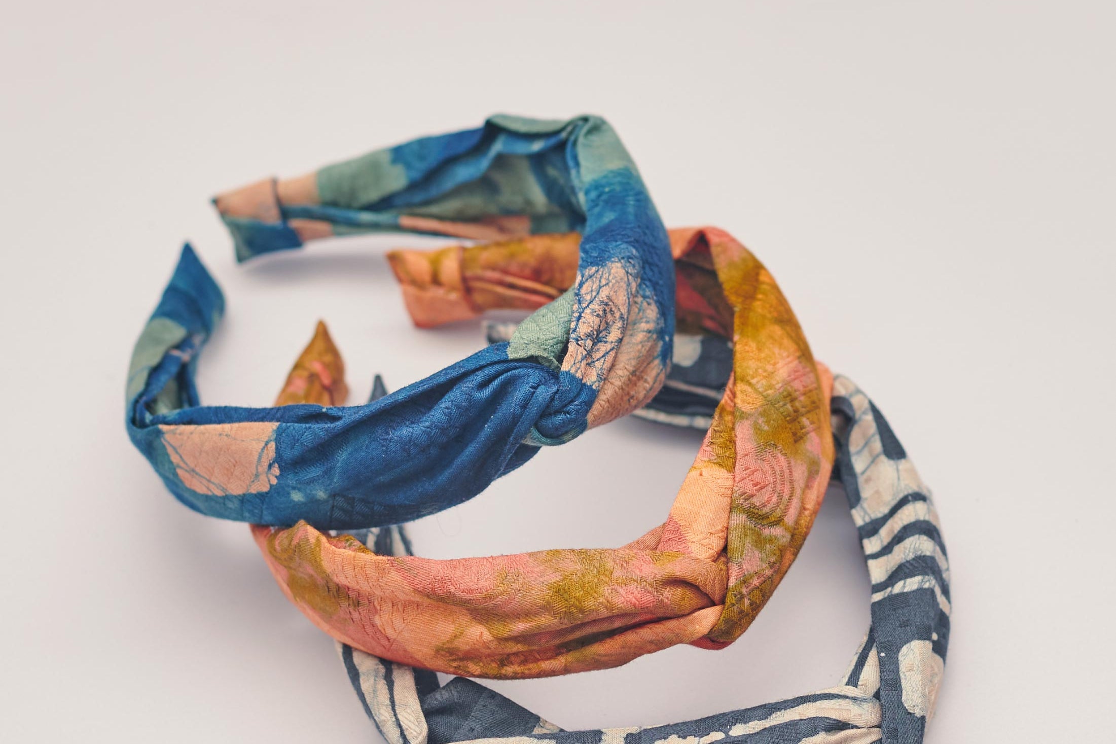 Set of three hand-dyed batik print headbands by GEOMETRIC. 