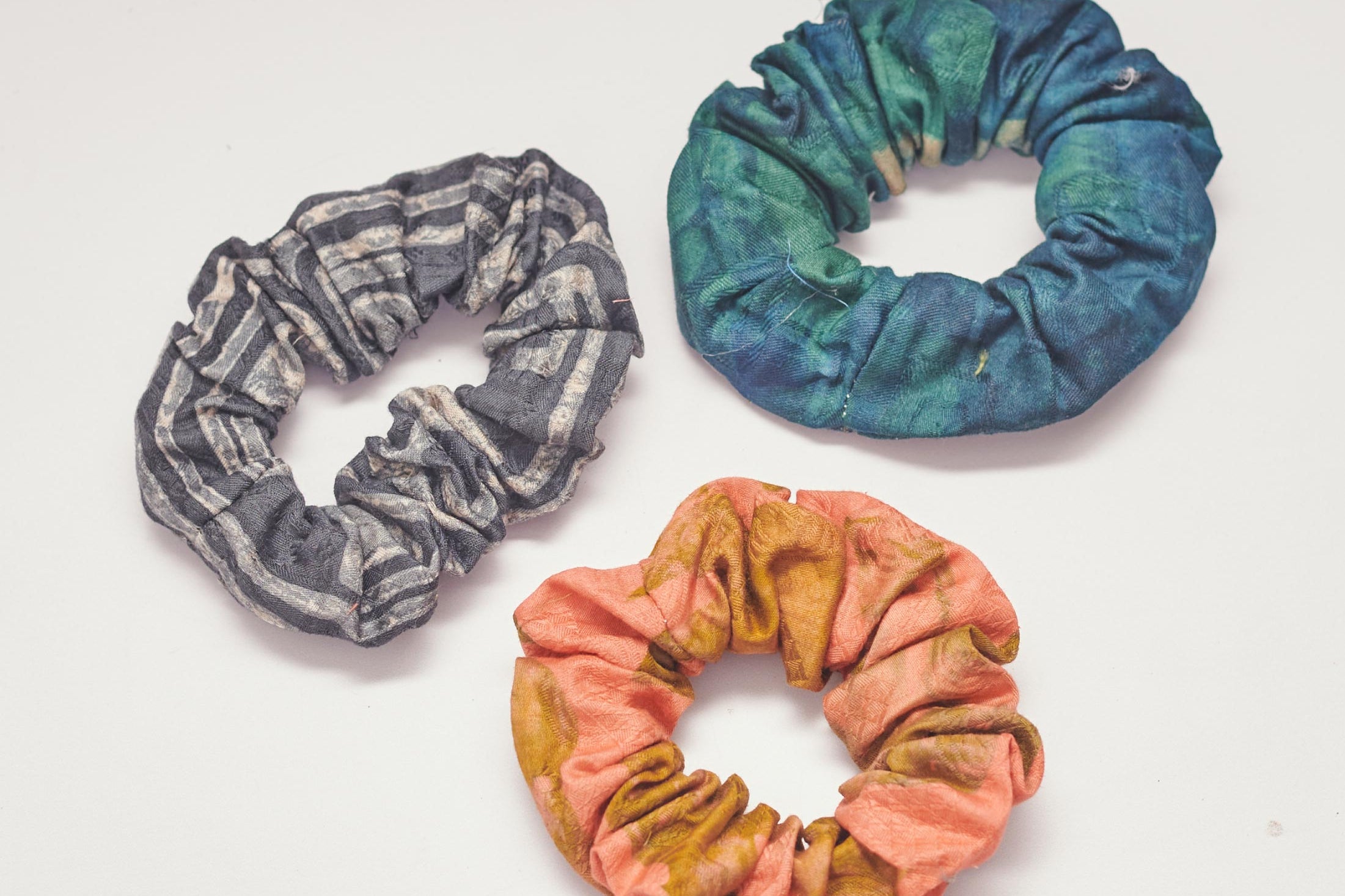 Set of three hand-dyed batik print scrunchies by GEOMETRIC. 