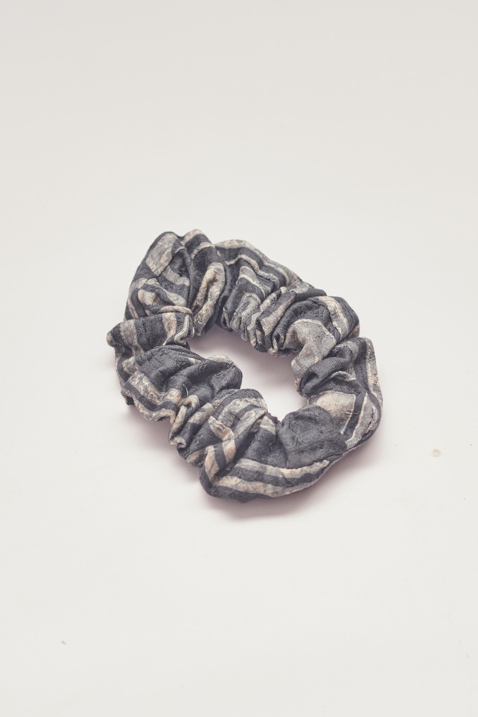 Charcoal hand-dyed Coco batik print scrunchy by GEOMETRIC. 