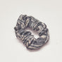 Charcoal hand-dyed Coco batik print scrunchy by GEOMETRIC. 