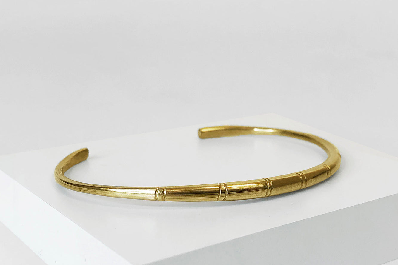 Brass adjustable Etched Bangle by GEOMETRIC. 