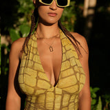 Woman wearing yellow hand-dyed batik print Halter Top by Geometric. 
