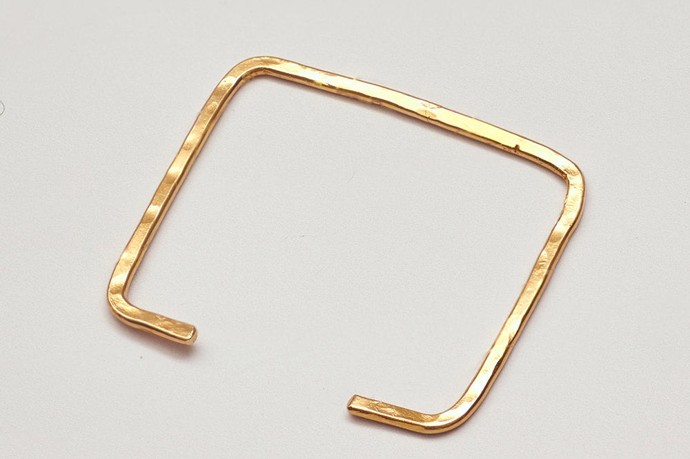 Hammered brass square shape bangle by GEOMETRIC. 