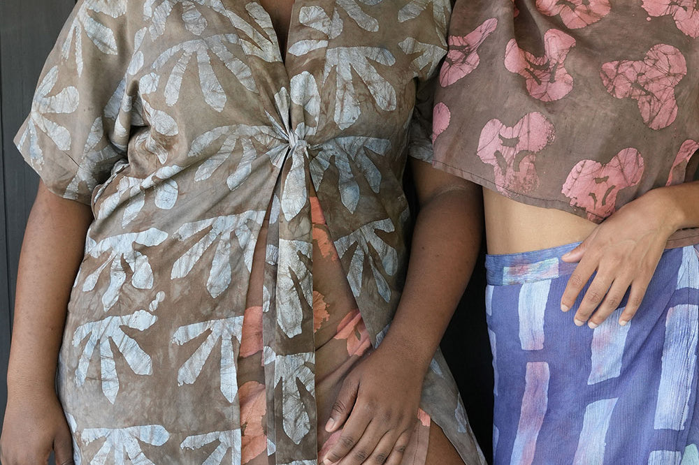 Two women standing together with woman on the left wearing batik print Wedgewood Kimono by Geometric. 