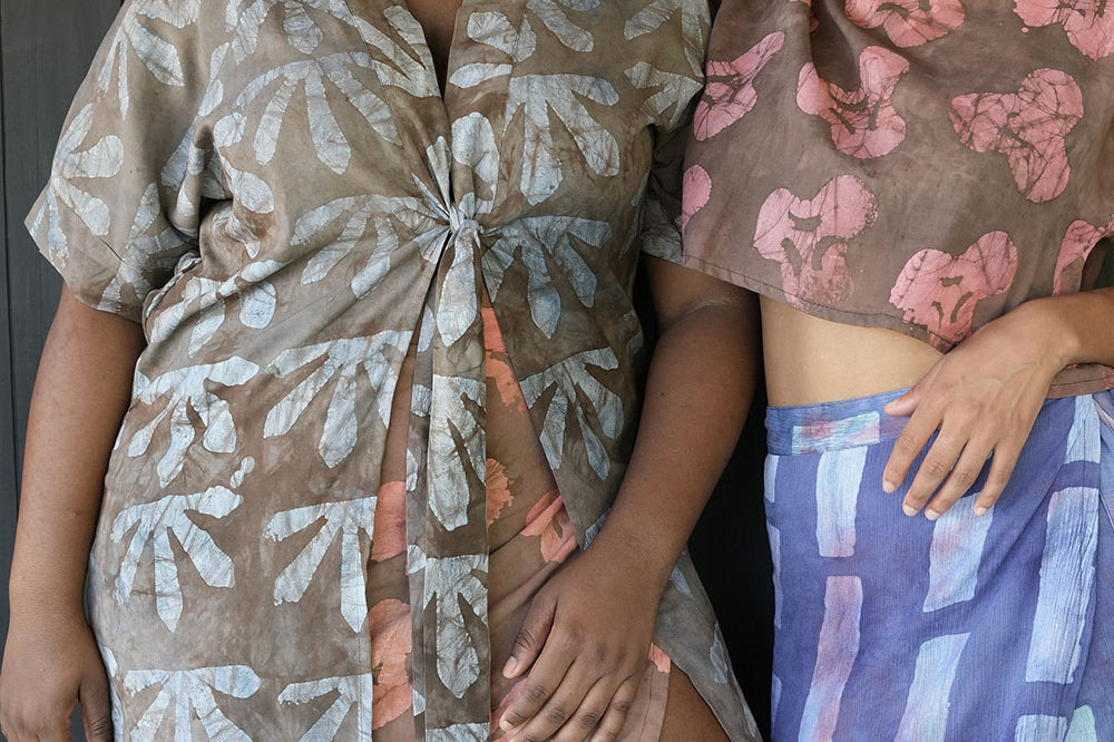 Two women standing together with woman on the left wearing batik print Wedgewood Kimono by Geometric. 