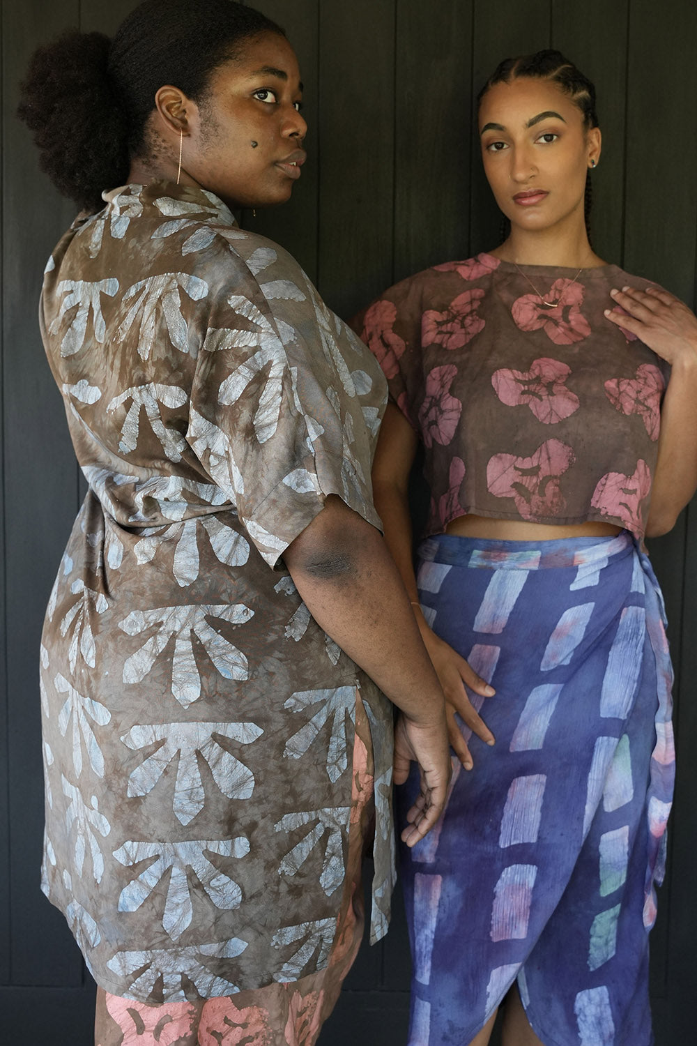 Two women standing together with woman on the left wearing batik print Wedgewood Kimono by Geometric. 