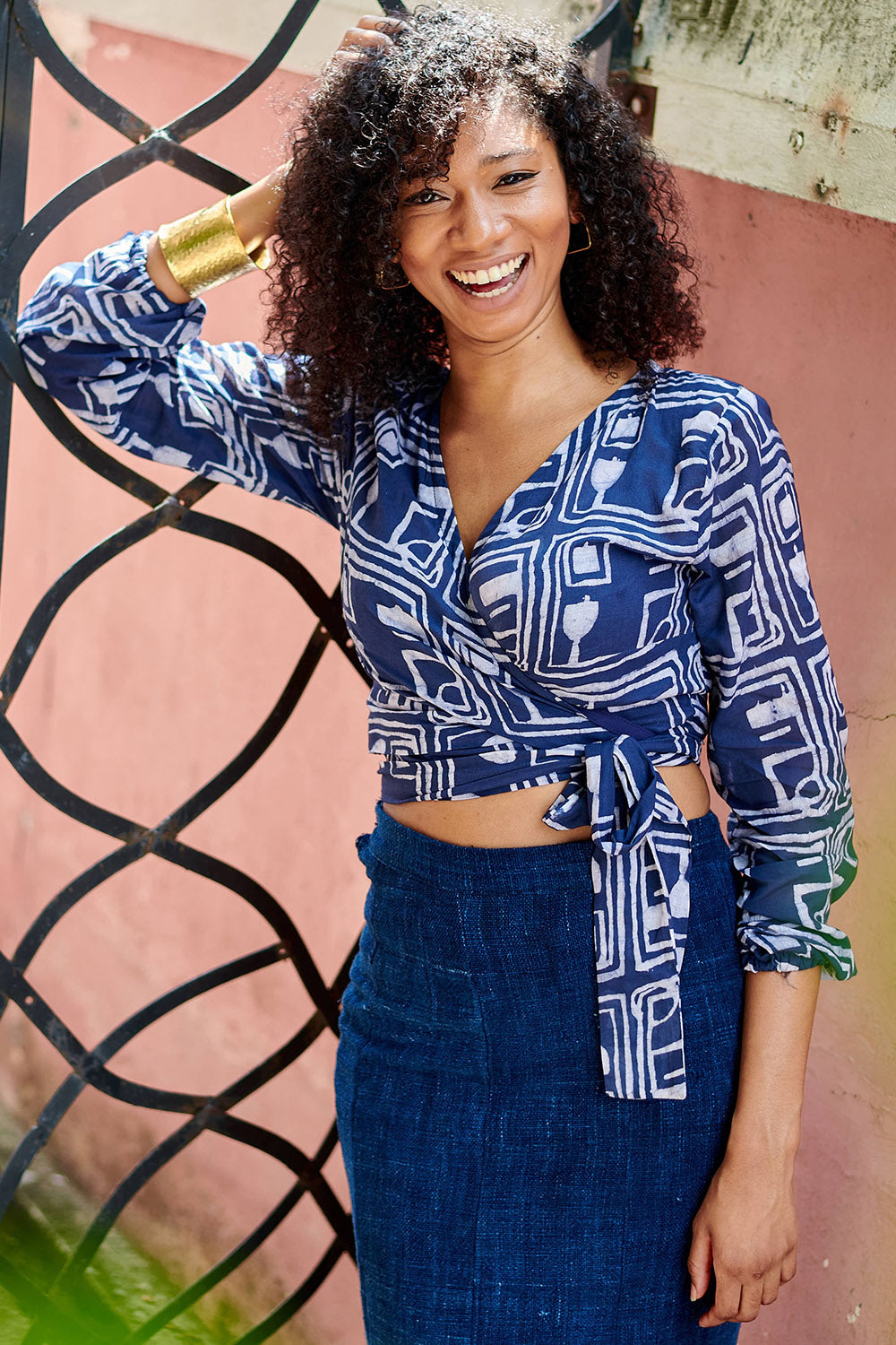 Woman wearing blue hand-dyed batik Coco print long sleeve wrap top by GEOMETRIC. 
