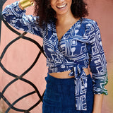 Woman wearing blue hand-dyed batik Coco print long sleeve wrap top by GEOMETRIC. 
