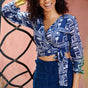 Woman wearing blue hand-dyed batik Coco print long sleeve wrap top by GEOMETRIC. 