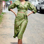 Woman wearing matching green hand-dyed batik Garden Party print long sleeve wrap top and wrap skirt by GEOMETRIC. 
