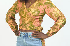 Woman wearing hand-dyed orange Birds of Paradise batik print long sleeve wrap top by GEOMETRIC. 