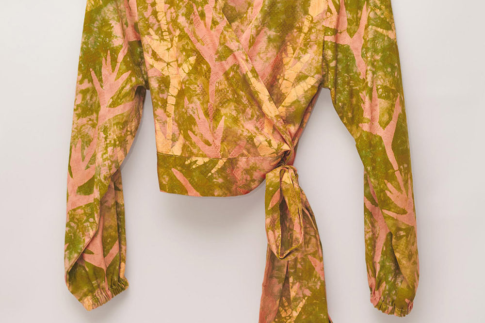 Hand-dyed orange Birds of Paradise batik print long sleeve wrap top by GEOMETRIC. 