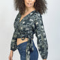 Woman wearing charcoal hand-dyed batik Coco print long sleeve wrap top by GEOMETRIC. 