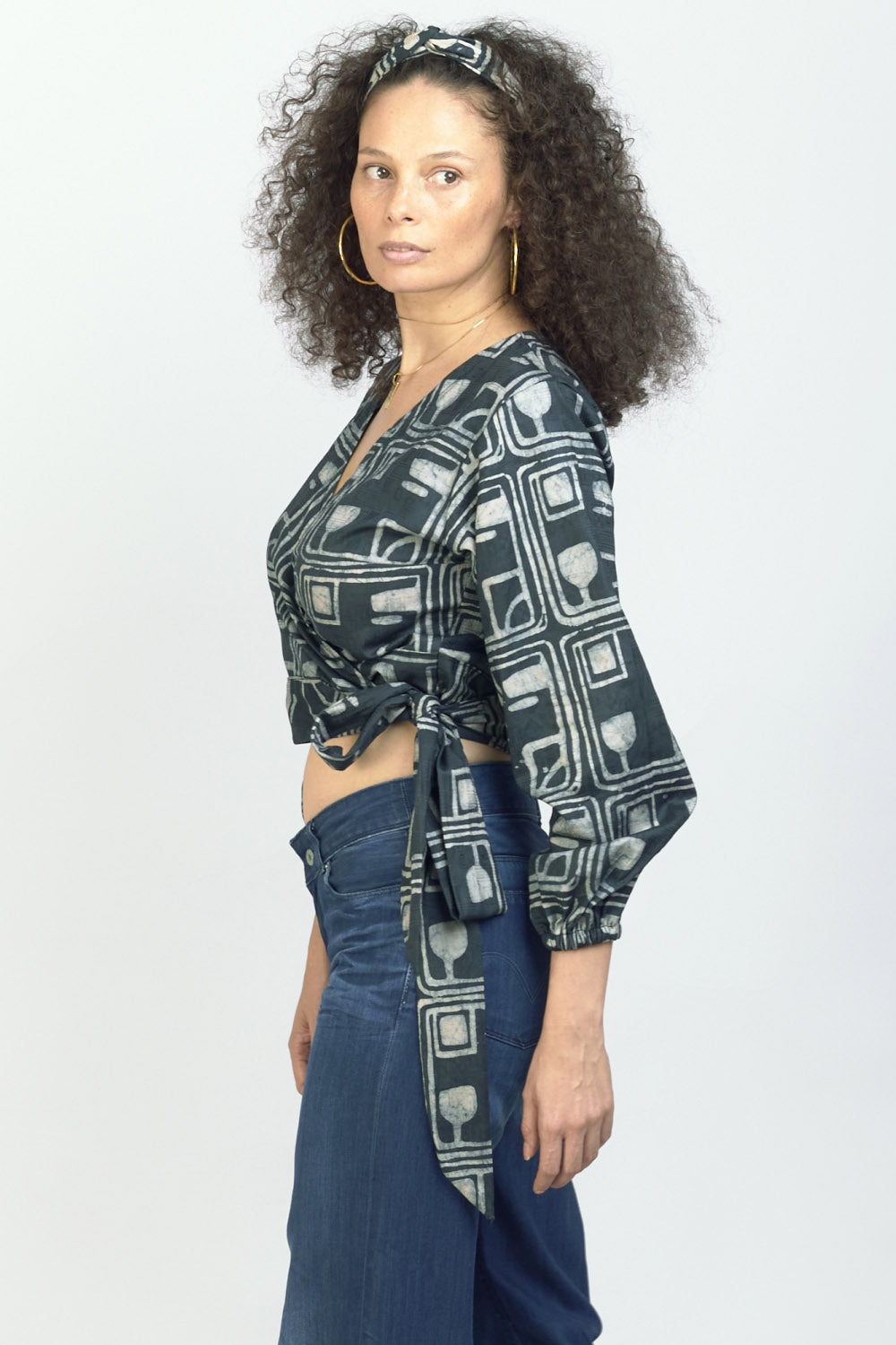 Woman wearing charcoal hand-dyed batik Coco print long sleeve wrap top by GEOMETRIC. 