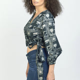 Woman wearing charcoal hand-dyed batik Coco print long sleeve wrap top by GEOMETRIC. 