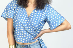 Woman wearing hand-dyed blue Polka dot batik print Short Sleeve Wrap Top by GEOMETRIC. 