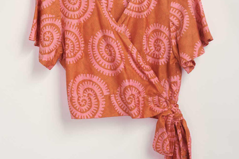 Hand-dyed pink and orange Shea Shell dot batik print Short Sleeve Wrap Top by GEOMETRIC. 