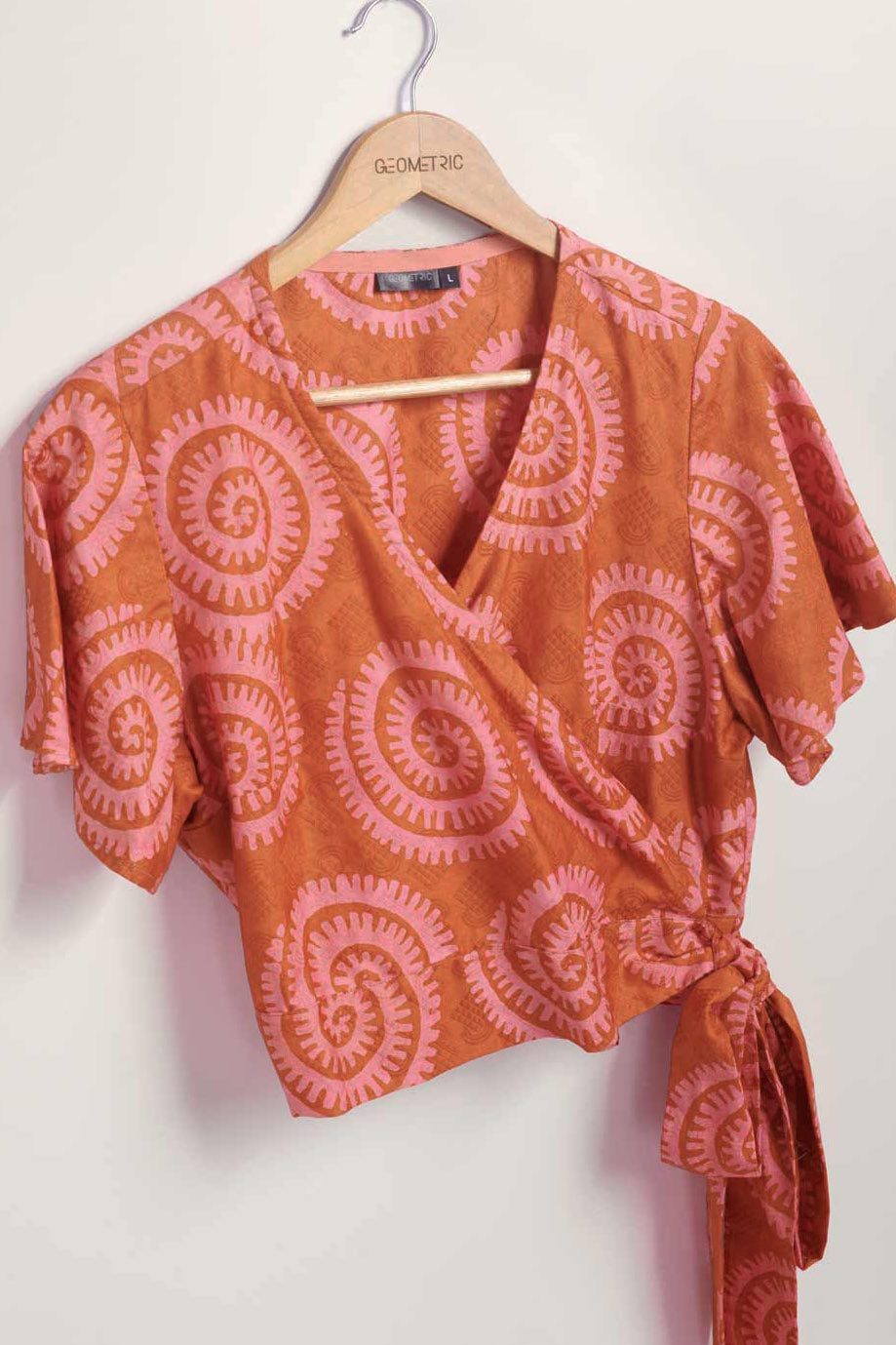 Hand-dyed pink and orange Shea Shell dot batik print Short Sleeve Wrap Top by GEOMETRIC. 