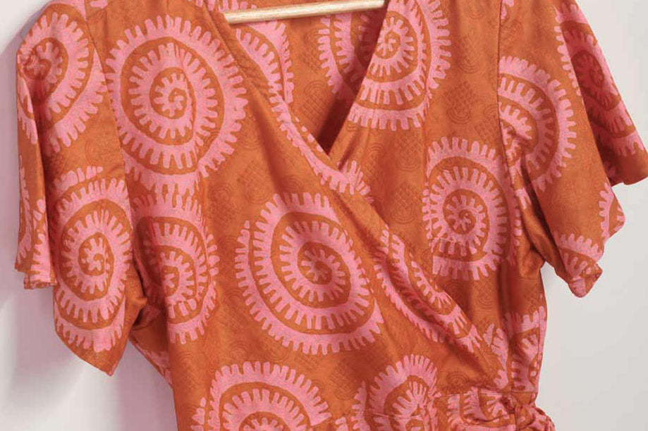 Hand-dyed pink and orange Shea Shell dot batik print Short Sleeve Wrap Top by GEOMETRIC. 