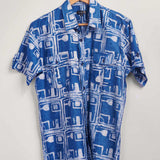 Hand-dyed blue Coco batik print short sleeve button up shirt by GEOMETRIC. 